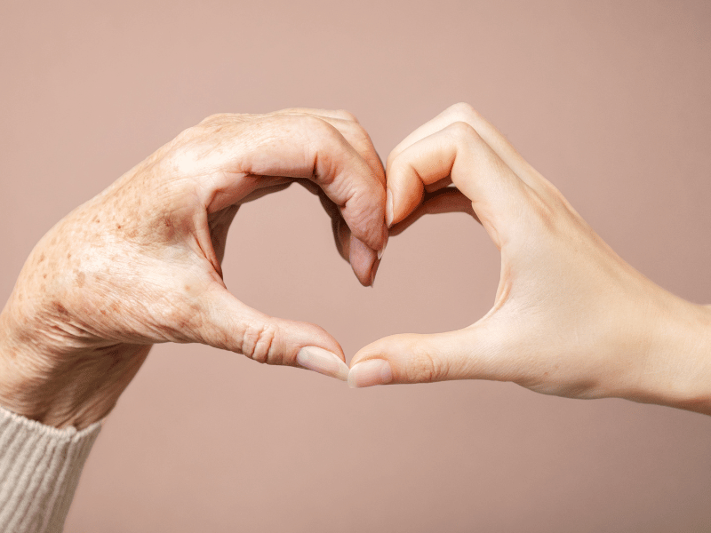 Life Extension Europe: Heart made up of a young and old persons' hands on a pink beige background 